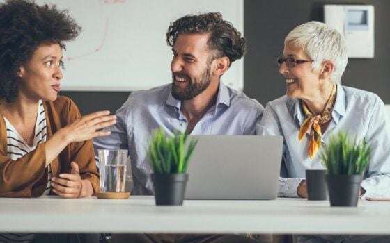 Group of coworkers sitting and working together on new startup project