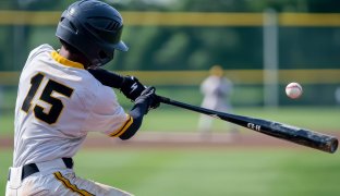 photography rear shot, A close-up action shot of a baseball player in a white with the number 15, swinging a bat powerfully towards an oncoming baseball. The player is wearing a black helmet, and the background shows a blurred baseball field with a yellow fence and distant players. The scene captures the intensity and motion of the swing, with the baseball just about to make contact with the bat --ar 3:2 --quality 2 --v 6.1 Job ID: 2d0869d8-ffc5-4cdd-a6f7-9f7425fe8107