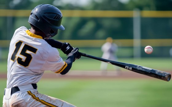 photography rear shot, A close-up action shot of a baseball player in a white with the number 15, swinging a bat powerfully towards an oncoming baseball. The player is wearing a black helmet, and the background shows a blurred baseball field with a yellow fence and distant players. The scene captures the intensity and motion of the swing, with the baseball just about to make contact with the bat --ar 3:2 --quality 2 --v 6.1 Job ID: 2d0869d8-ffc5-4cdd-a6f7-9f7425fe8107